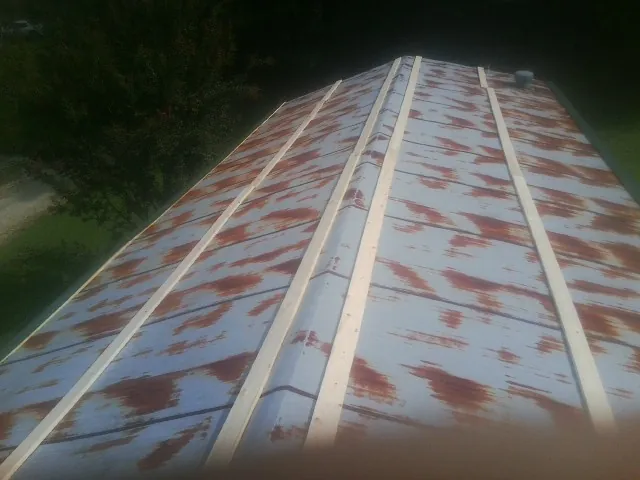 Rusted metal roof panels with new wood purlins before replacement — Storm Damage Roof Repair in Carmen by Roofing Brothers