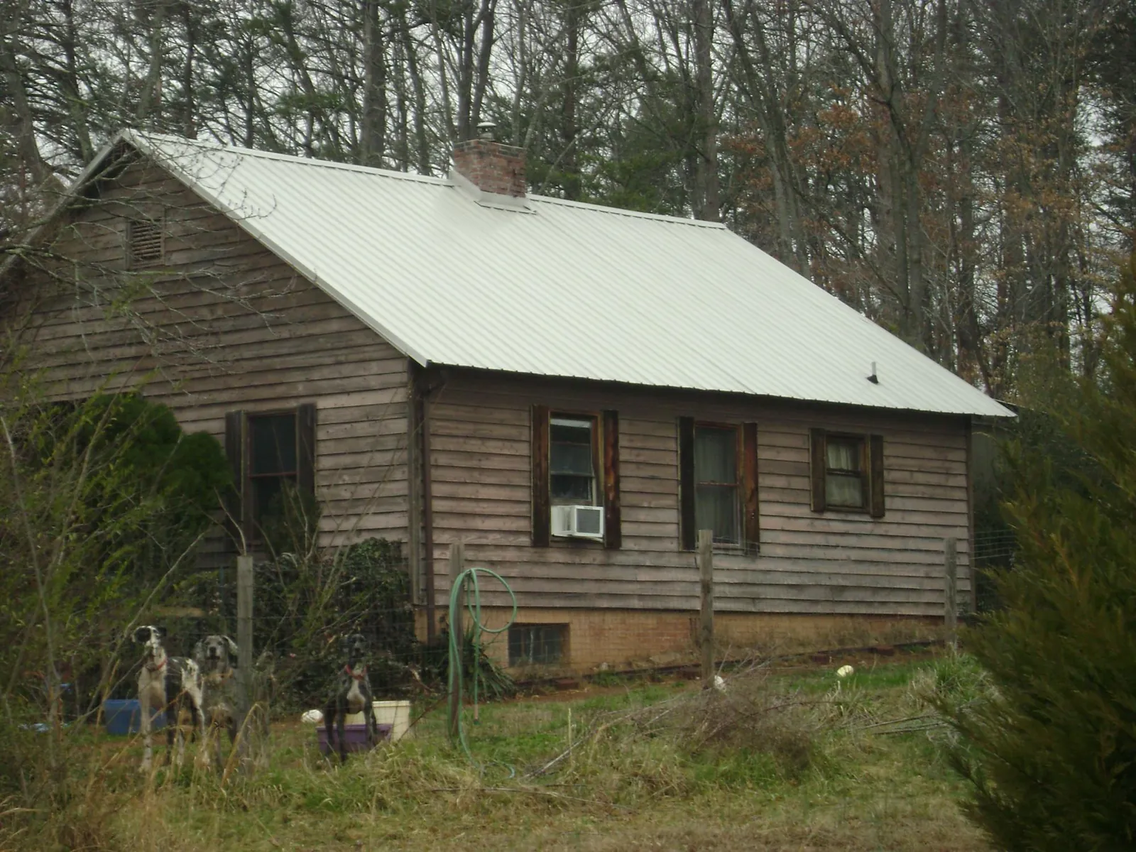 White metal roof on an old wood sided farmhouse, from a Metal Roof Installation job in Carmen